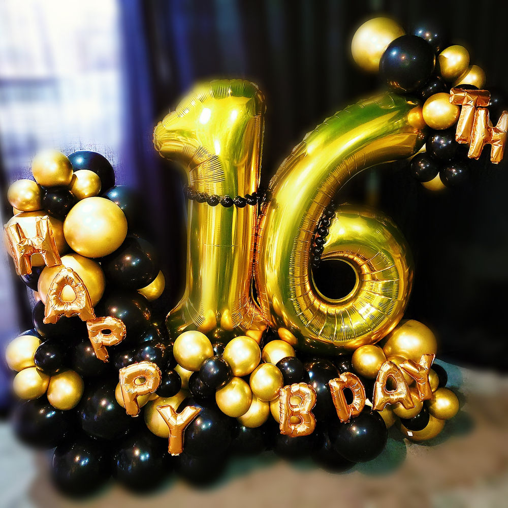 Black and gold balloon installation spelling a milestone birthday number.
