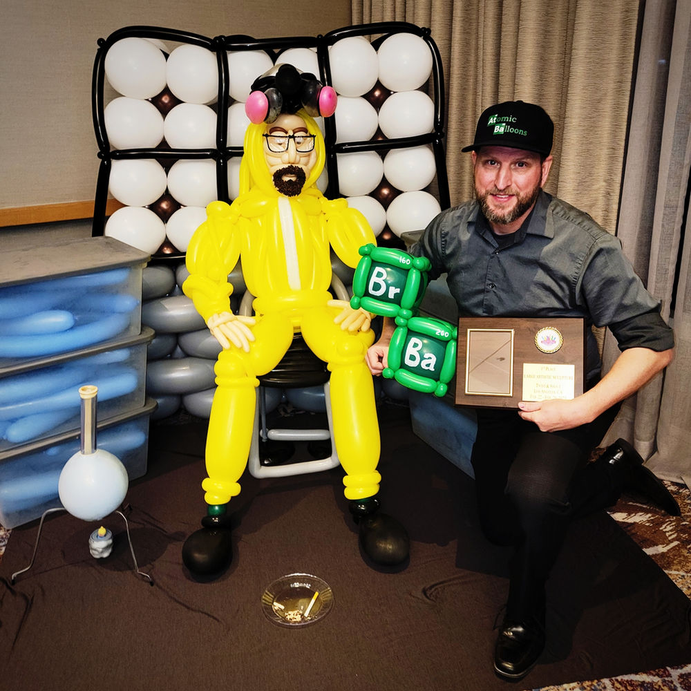 Atomic Balloon Company artists photographed with the award-winning life-size Breaking Bad balloon display and its competition plaque.