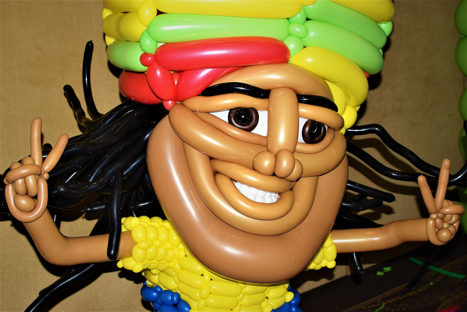 Large balloon sculpture of a stylised character head with detailed hair and facial features.